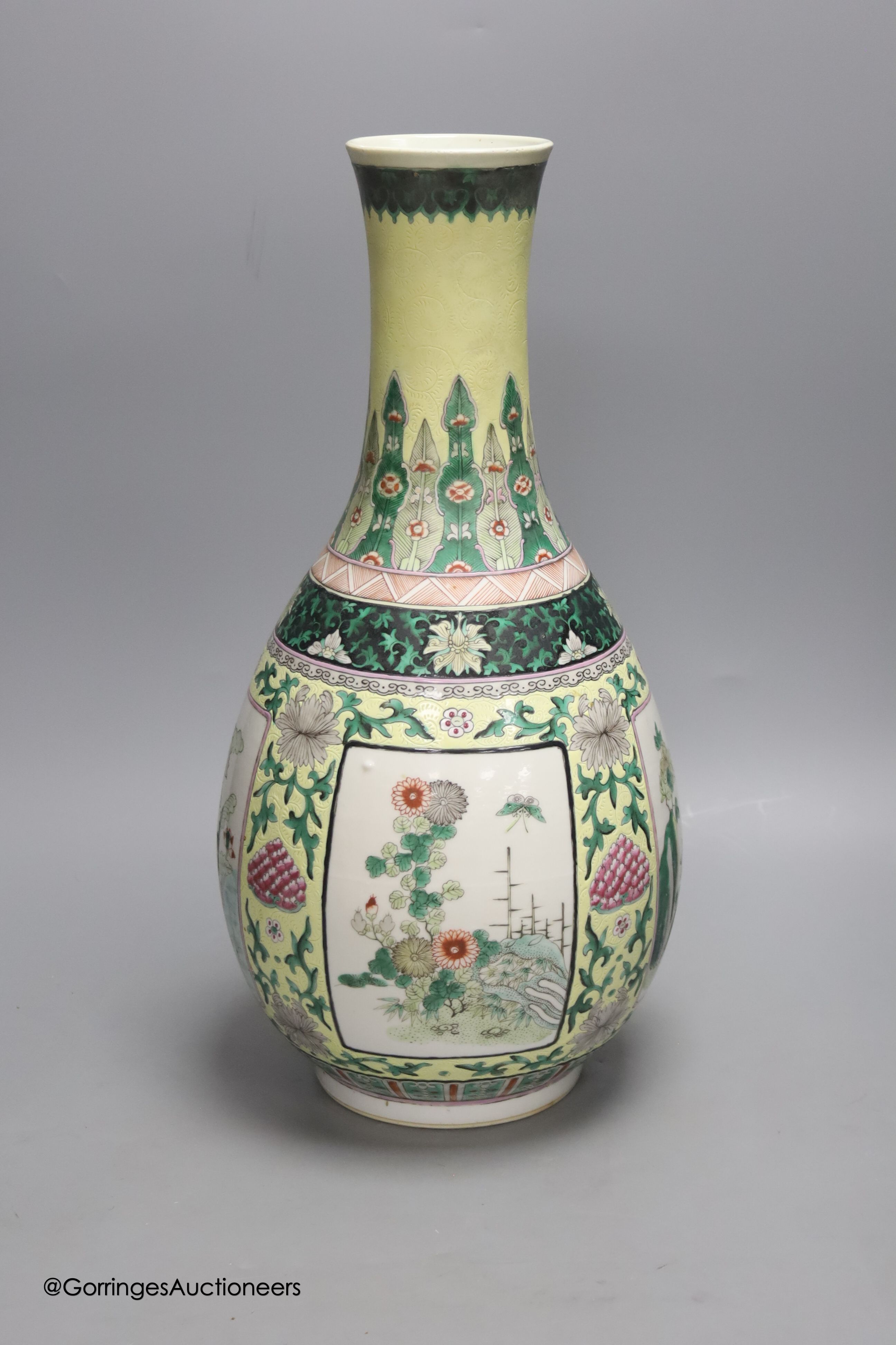 A large 19th century Chinese famille verte yellow ground bottle vase, height 47cm, restorations